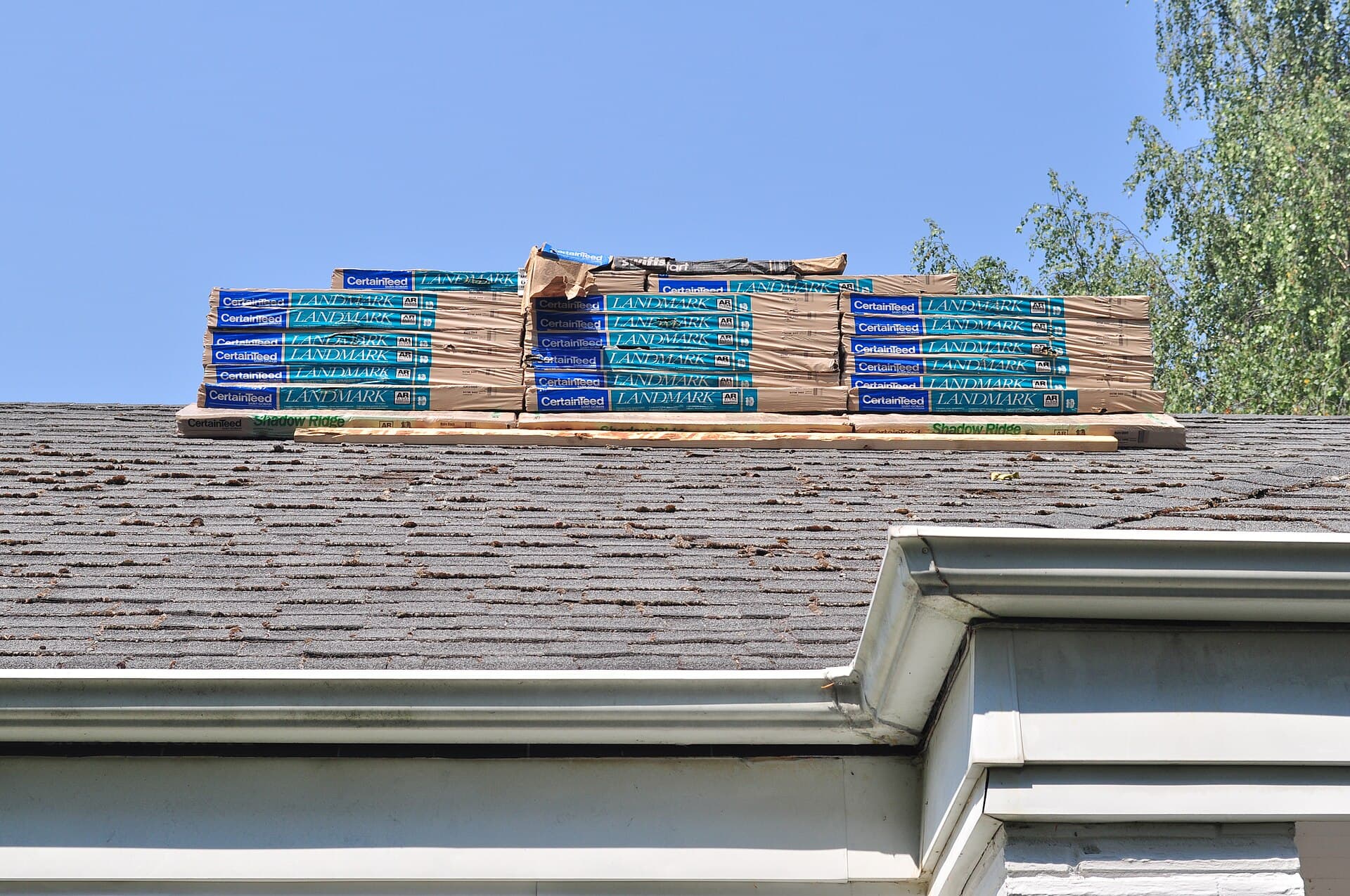 Bundles of new shingles stacked on a roof ridge